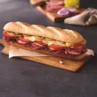 Italiano Sub · Ham, salami, provolone cheese, banana peppers, tomatoes, red onions, and sub dressing.