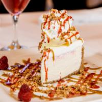 White Chocolate Raspberry Cheesecake · A creamy, soft raspberry infused cheesecake topped with fresh raspberries, whipped cream and...