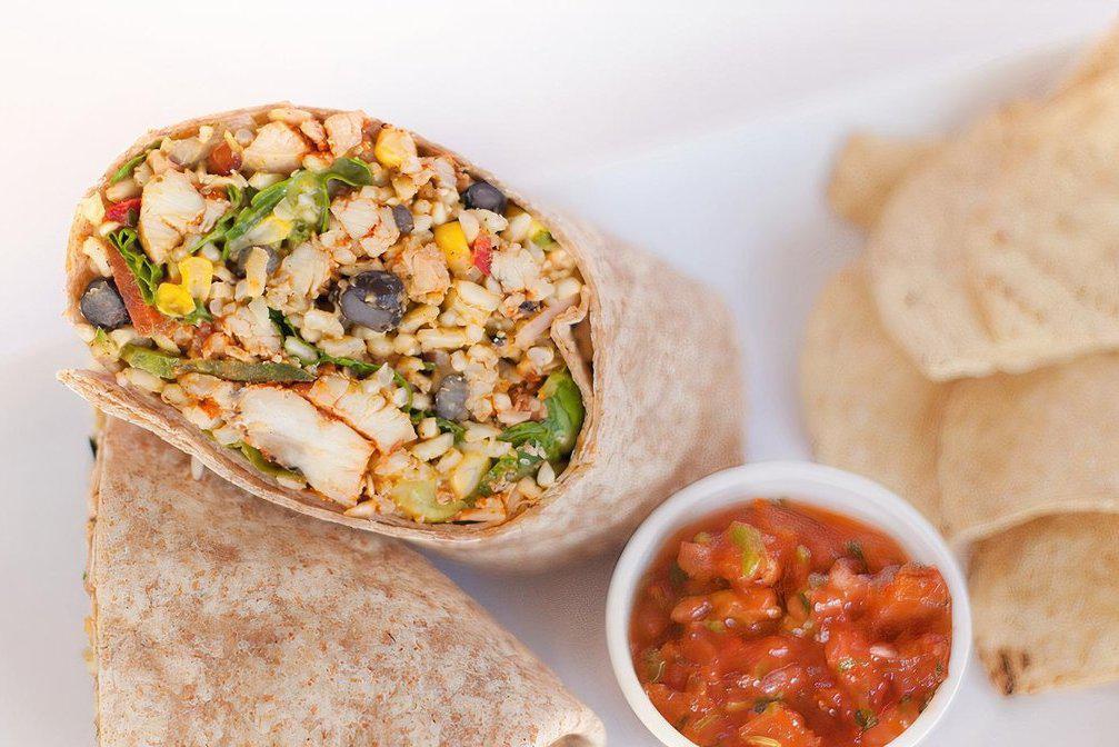Fiesta Wrap · Cilantro lime brown rice, spicy chicken, spinach, elote street corn, black beans, red peppers, jalapeños, red onion, and avocado cilantro dressing.  Served in whole wheat tortilla with choice of side.