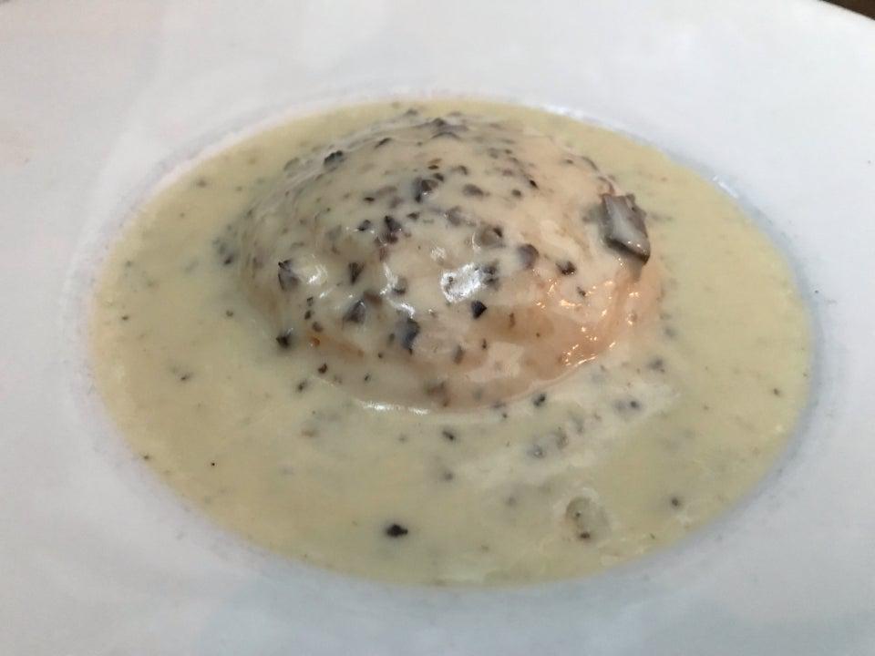 Polenta Tartufata · Fresh polenta filled with robiota cheese in a black truffle sauce.