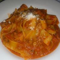Pappardelle al Ragu di Vitello · Home made pasta ribbons sauteed with a ragout of veal and montasio cheese.