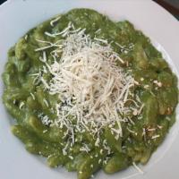 Cavatelli al Fior di Pesto · Home made pasta shells in a light and creamy pesto sauce topped with shaved ricotta.