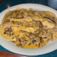 Mezzelune Boscaiola · Filled with prosciutto and asiago cheese in a creamy wild mushroom sauce.