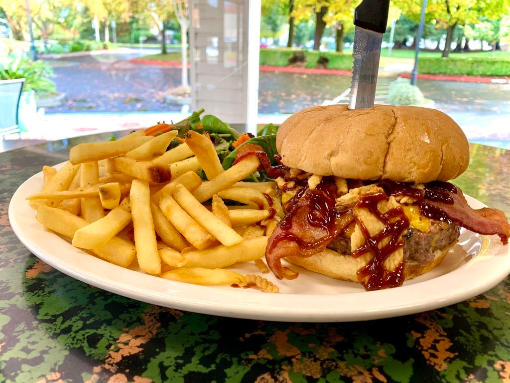 BBQ Burger · Served with bacon, cheddar cheese, onion strings and BBQ sauce. 