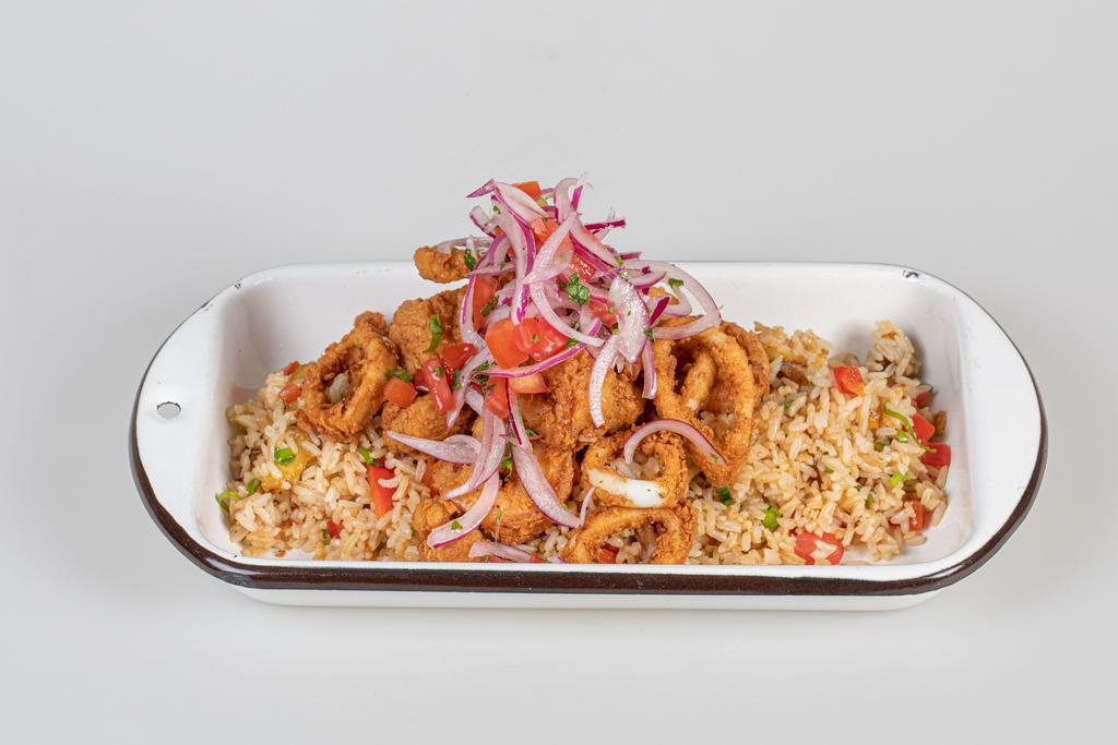 Jalea Rice · Wok rice with sweet plantains, red bell peppers, green onions, deep-fried calamari, shrimp and white fish with sarsa criolla.
