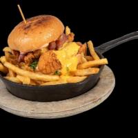 Fried Chicken Burger · 8 oz. of crispy chicken in a brioche bun with lettuce and melted cheddar cheese. Served with...