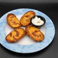 Potato Skins · Homemade extra large, double-cooked skins topped with melted cheese and bacon, served with a...