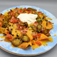 Nachos · Tortilla chips topped with black bean chili, cheddar and Jack cheese, pico de gallo and sour...