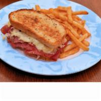 Reuben · Sliced corned beef, topped with sauerkraut, melted Swiss cheese and thousand island dressing...