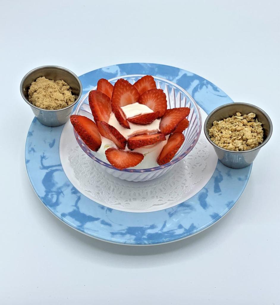 Greek Yogurt · Strained Greek yogurt with fresh strawberries and granola.