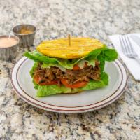 Patacon · Fried plantain sandwich. Fried green plantain, chicken, beef or pork, lettuce, tomato, garli...