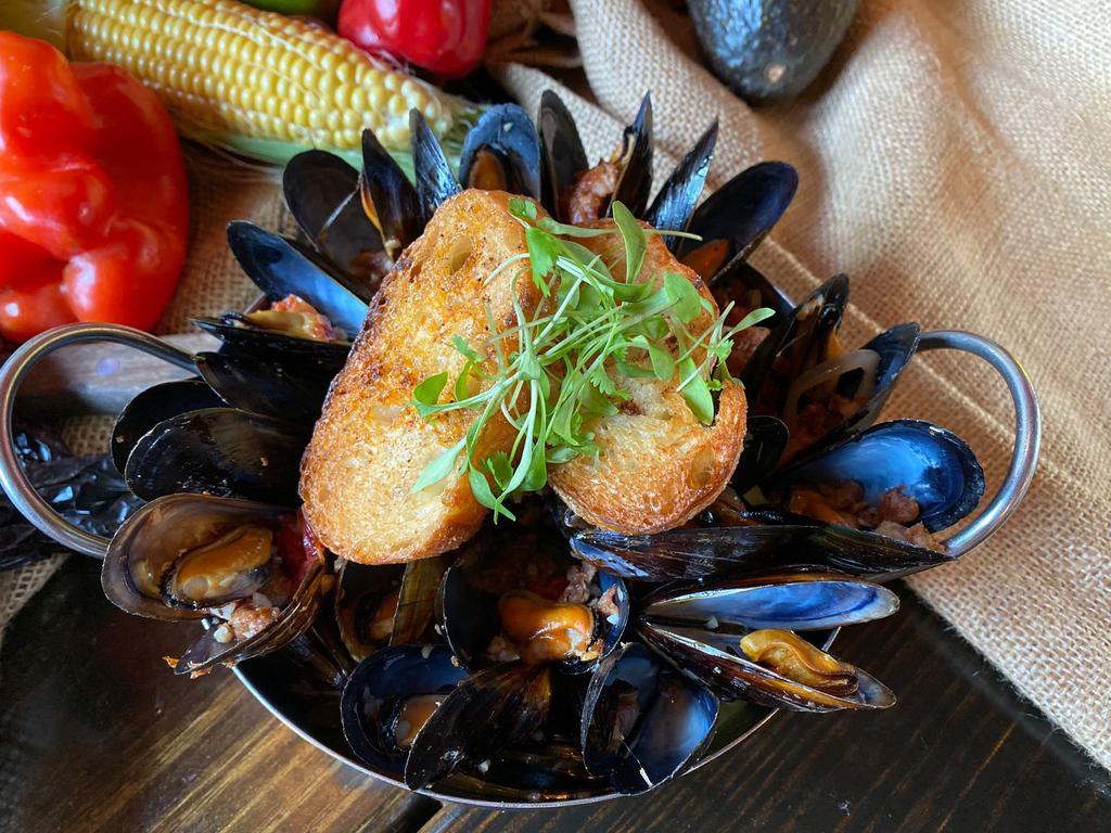 Mussels · Chorizo, shallots, sun dried tomatoes and tequila-lime butter broth.