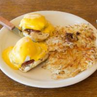 Susana Eggs Benedict  · Poached eggs with Canadian bacon on an English muffin with Hollandaise sauce, served with co...