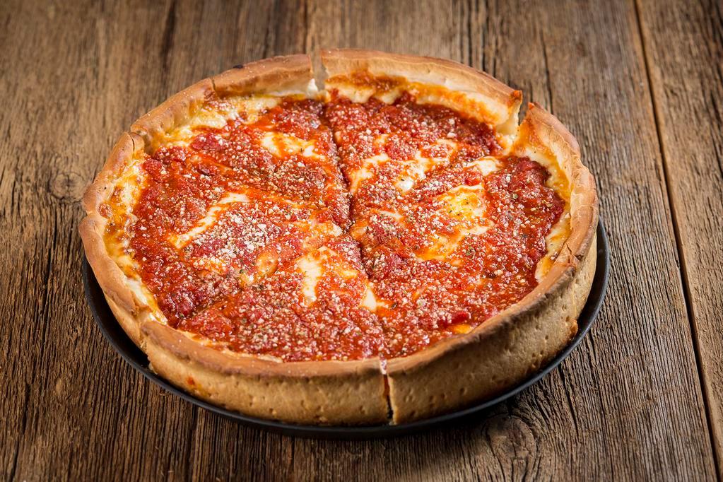 Chicago-Style Deep Dish Pizza · Chicago’s famous deep dish is a buttery crust filled with mounds of mozzarella cheese and topped with chunky pomodoro tomatoes.