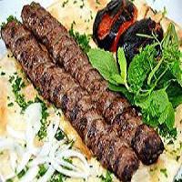 K1. Kabob Koobideh and Bread · 2 skewers of juicy ground beef kabobs served over bread, with sides of onions and grilled tomatoes.