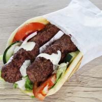 M9. Ground Beef Kabob Wrap · Lettuce, onions, tomatoes, cucumbers, tzatziki and feta cheese, olives wrapped with pita bre...