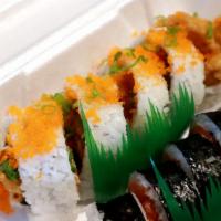 Spider Roll · Deep fried soft shell crab, crab meat, avocado, cucumber, gobo and sprouts topped with masag...