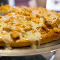 Buffalo Chicken Pizza · Tender pieces of chicken breast tossed in hot sauce topped with ranch dressing.