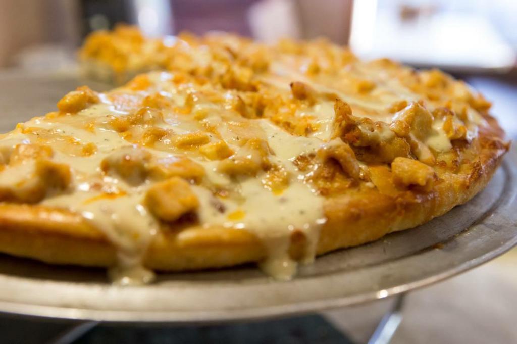 Buffalo Chicken Pizza · Tender pieces of chicken breast tossed in hot sauce topped with ranch dressing.