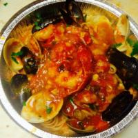 Seafood Combo Marinara · Shrimps, calamari, mussels and clams. Served over pasta with a small salad. 