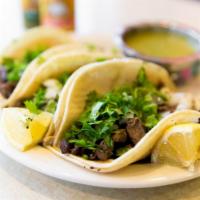 Carne Asada Tacos (3) · Beef. Soft corn tortillas served with cilantro, onions and side salsa.