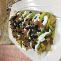 Smoked Brisket Nachos · With guacamole, sour cream, pico de gallo, jalapenos, beans and cheese.