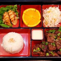 Beef Patty Bento Box · Comes with Beef patty, cabbage salad with special sauce, 2 fried dumplings, rice, orange, an...