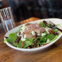 Poached Goat Salad · Red wine poached pear, mixed leaf, pecans, blue cheese, goat cheese, and cider vinaigrette.