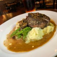 Peppered Filet · Crusted with black pepper corns, mushroom brandy sauce, creamy mashed potato, and asparagus.