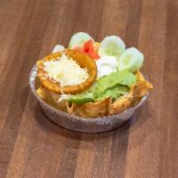 Fajita Taco Salad · Tortilla bowl filled with grilled chicken or steak cooked with peppers and onions topped wit...