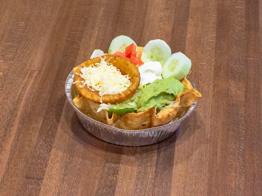 Fajita Taco Salad · Tortilla bowl filled with grilled chicken or steak cooked with peppers and onions topped with lettuce, guacamole, sour cream, tomatoes, and shredded cheese, cucumbers, and onion ring. 