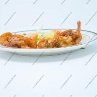 Camarones Empanizados · Breaded shrimp with a side. 