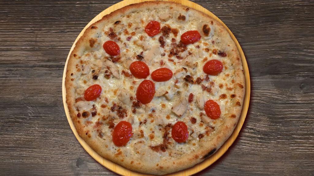 Chicken Club Pizza · White garlic pizza sauce, shredded mozzarella, grilled chicken, bacon and fresh tomatoes.