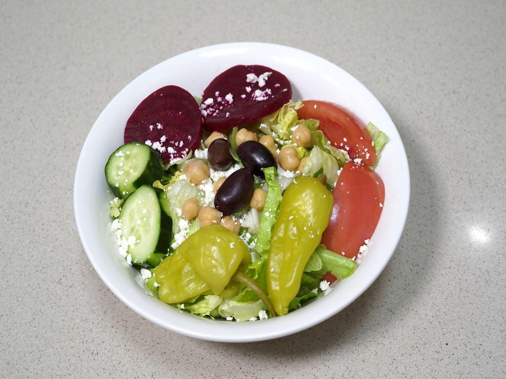 Leo's Famous Greek Salad · Comes with lettuce, tomato, cucumber slices, pepperoncini, Greek olives, beets, chickpeas, feta cheese and Leo’s famous Greek dressing. Add chicken breast or gyro meat for an additional charge.