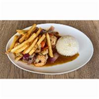 Shrimp Saltado · Wok seared shrimp, soy and oyster sauce, onion, tomato wedges, arroz con choclo, French fries