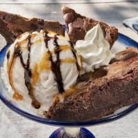 Brownie Overboard™ · Warm brownie wedges served with a scoop of vanilla ice cream. Topped with caramel, fudge, an...
