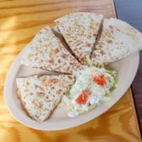 18. Quesadilla · Grilled flour tortilla with cheese and a choice of meat. Garnished with lettuce and tomato.