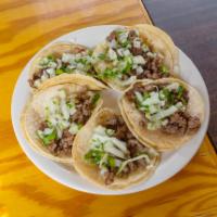 3. Taco Plate · 4 tacos with rice and beans. Topped with cilantro and onions.