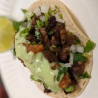 Carne asada street taco · 4.5’’ corn tortilla filled with carne asada, salsas, guacamole sauce, and cilantro or onions.