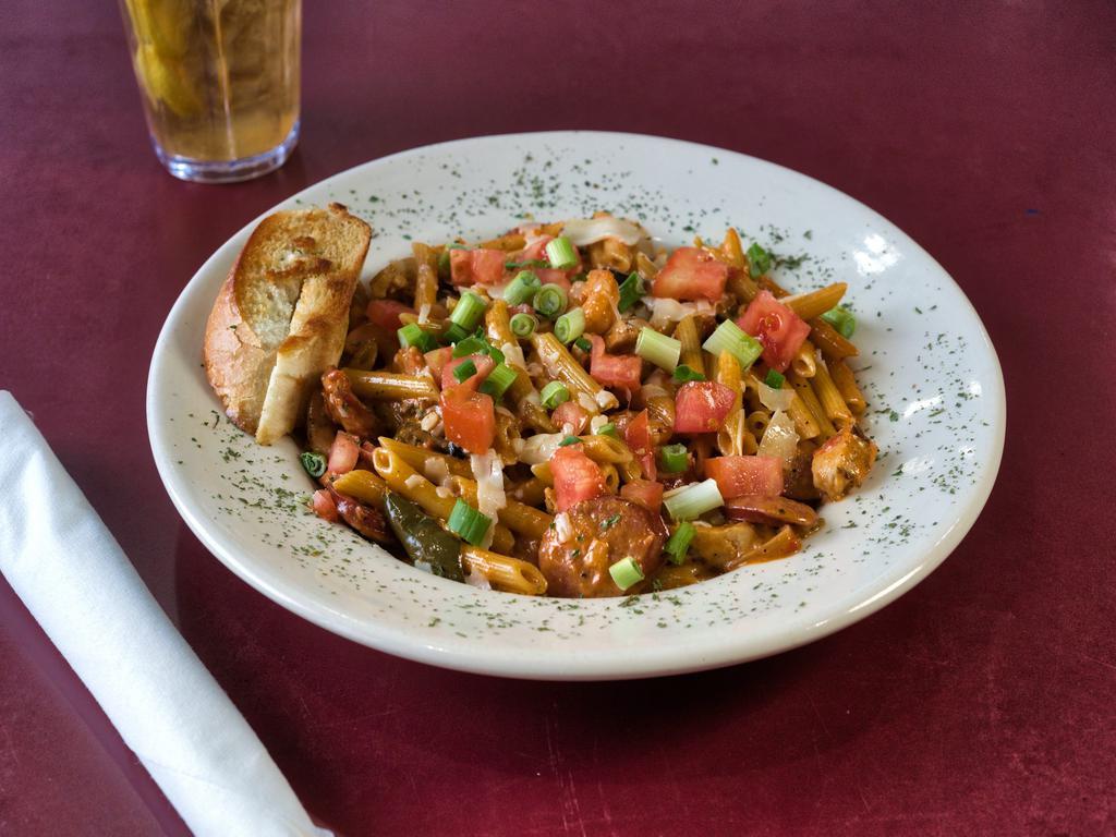 Jambalaya Pasta · Grilled chicken breast with spicy sausage, shrimp and peppers and onions in a spicy Cajun tomato Alfredo sauce with penne noodles. Garnished with fresh tomato and shaved Parmesan.
