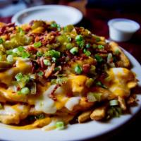 Loaded Cheese Fries · Fries smothered in melted cheddar and jack cheeses, bacon, jalapeños and chives. Ranch dress...