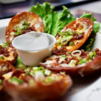 Potato Skins · Potato boats topped with melted cheddar and jack cheeses, bacon and chives. Sour cream on th...
