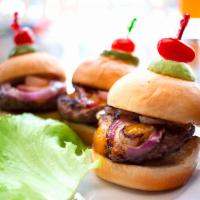 Texas Sliders · Three beef sliders with cheddar and grilled onions. Grape tomato and pickle garnish.