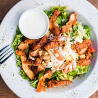 Buffalo Chicken Salad · Leafy greens topped with buffalo chicken strips, red onions, tomatoes, and bleu cheese crumb...