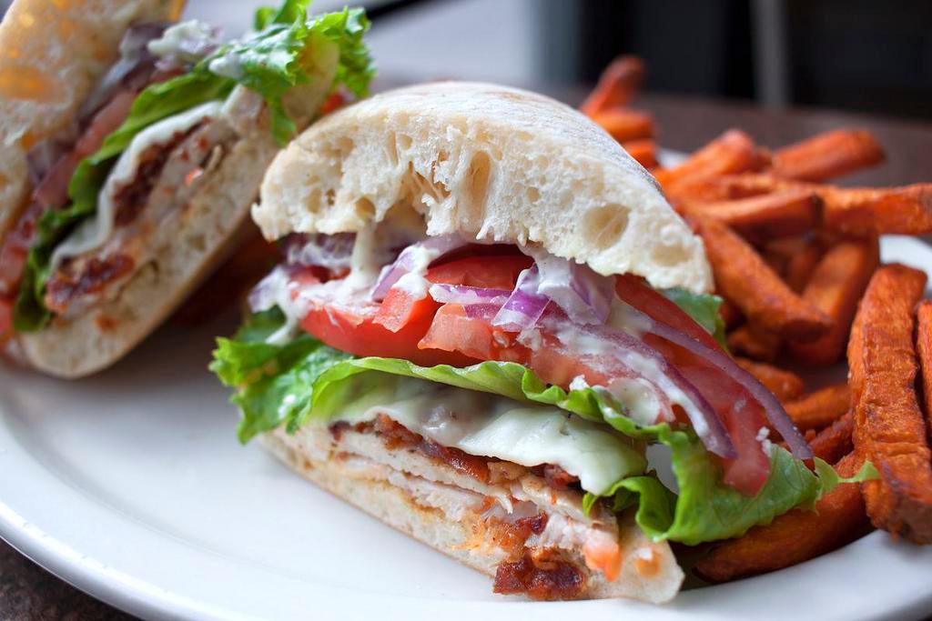 Pesto Chicken Sandwich · Grilled chicken breast with bacon, jack cheese, lettuce, tomato, red onion and pesto mayo. Served with fries.