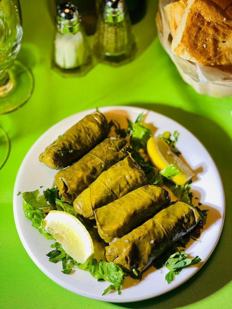 Stuffed Grape Leaves · 5 pieces. Vine grape leaves stuffed with rice, herbs, lemon juice and pine nuts. Contains nuts.