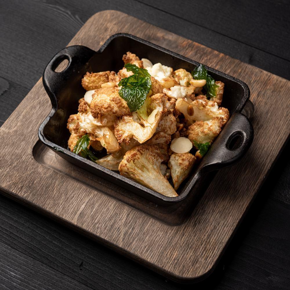 Caramelized Cauliflower · Caramelized cauliflower with toasted pine nuts, crispy mint leaves and lime sauce. Vegetarian and gluten free.