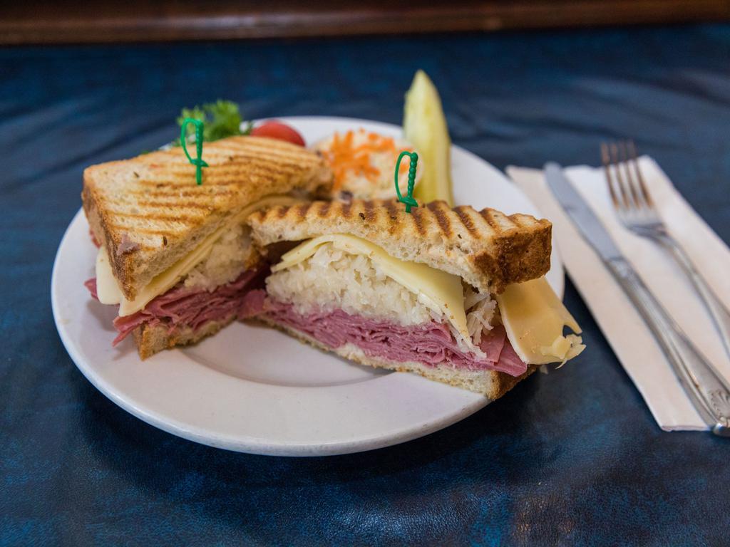 Reuben Melt · Corned beef, sauerkraut, Swiss cheese and Thousand Island dressing on your choice of bread grilled to perfection. Served with a pickle spear and your choice of side.
