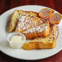 French Toast · Freshly baked egg bread in his secret french toast dip.