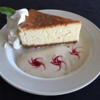 Lemon Cheesecake  · Lemon cheesecake on top of a lemon sour cream sauce drizzled with raspberry puree and finish...